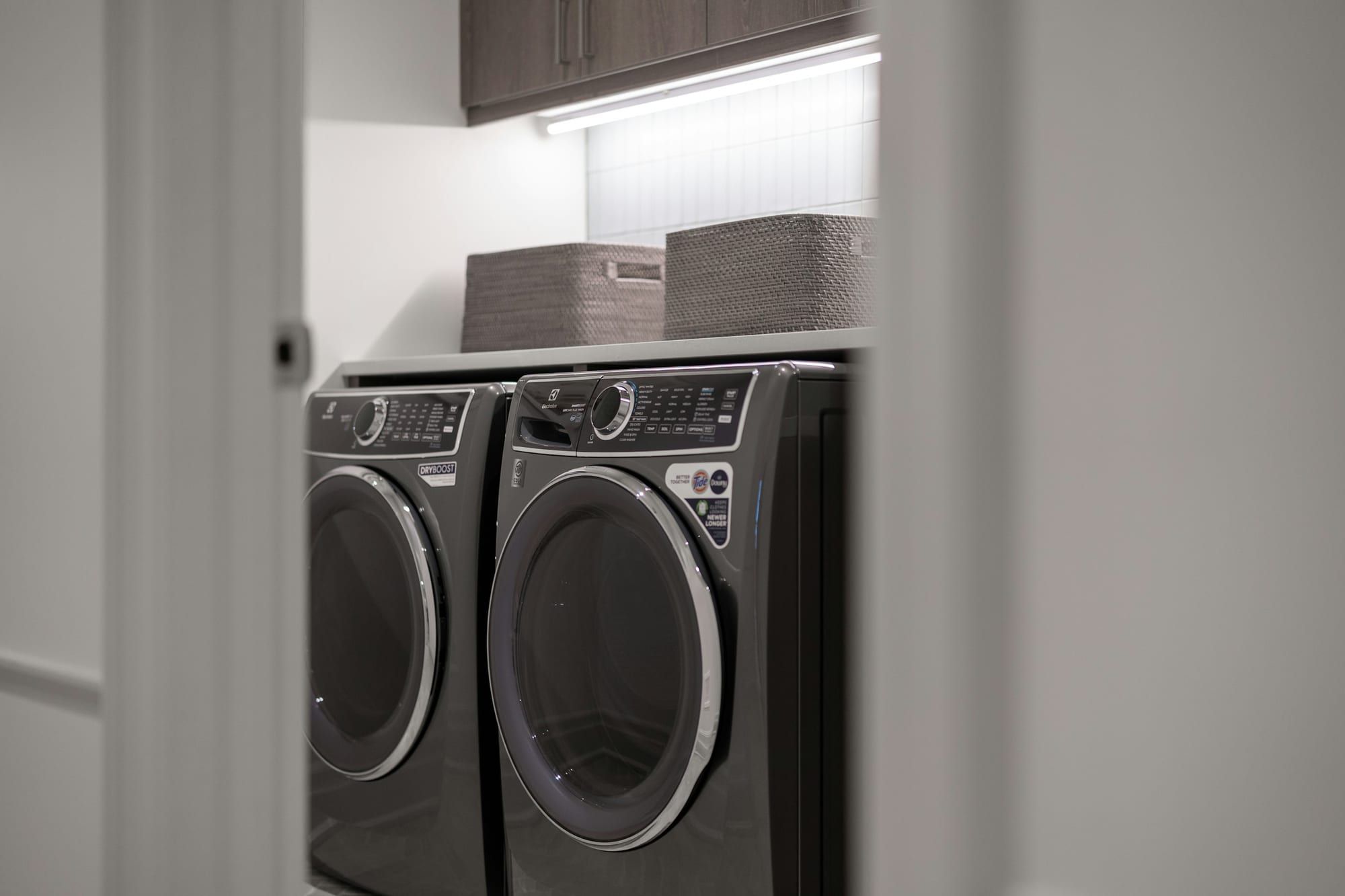 Front-load washer and dryer side by side in a home laundry room